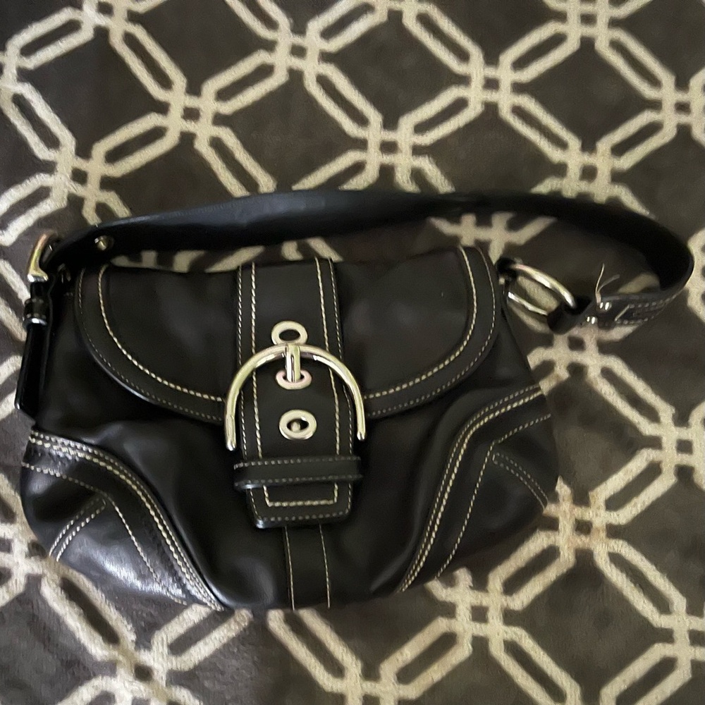 Black/silver small coach purse.  Adjustable strap handle/ inside zipper.